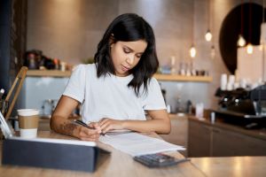 female business owner writing on paper
